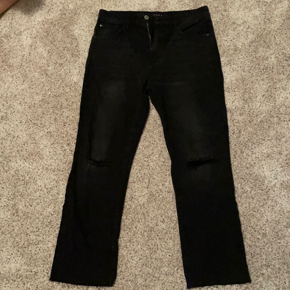 Boutique ripped knees and frayed bottom jeans.